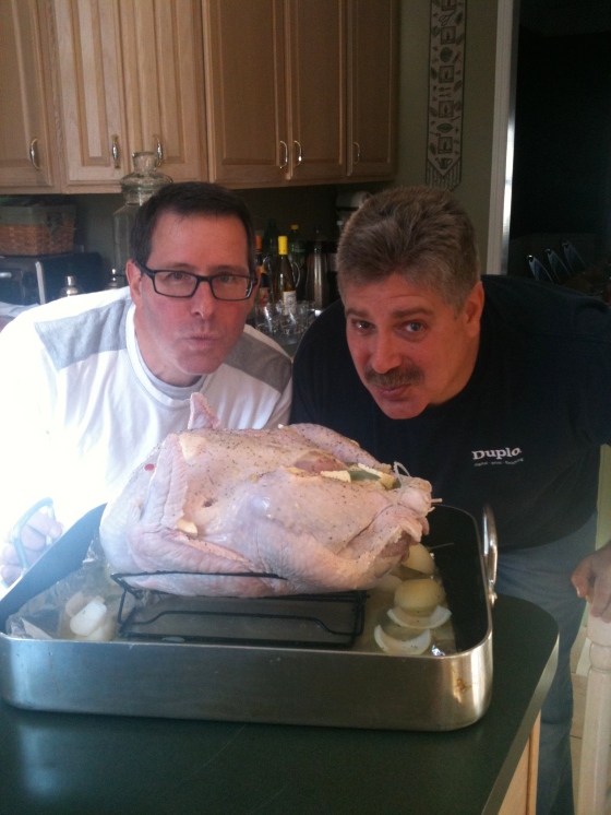 Ray and Scott kissing the turkey before it goes into the oven